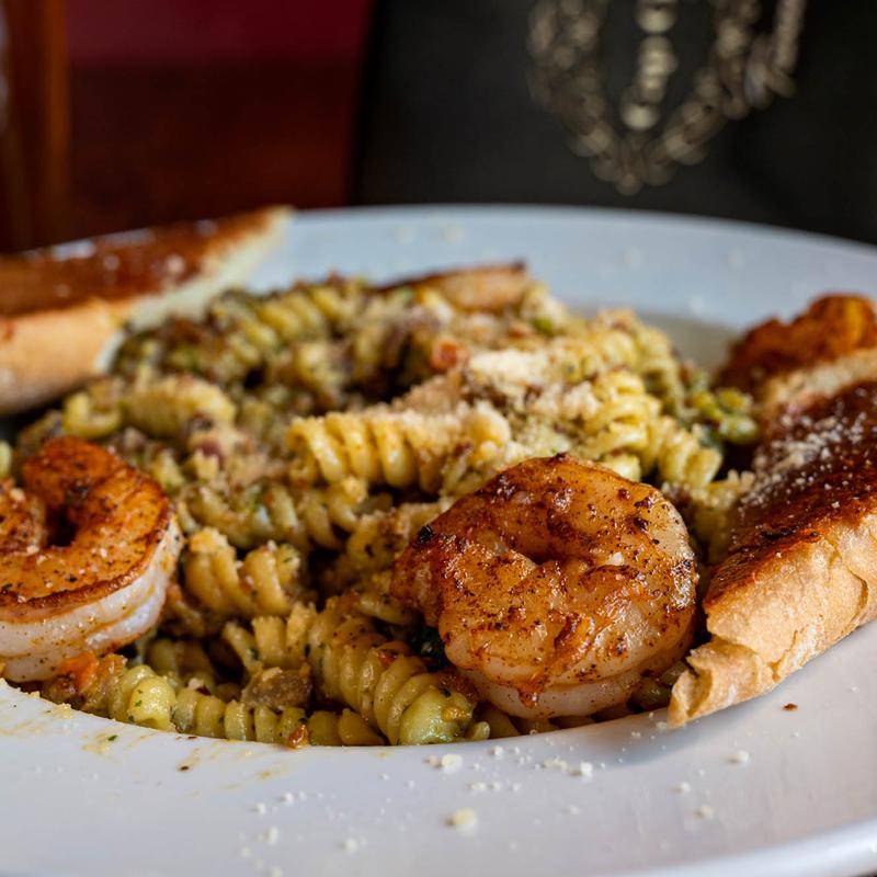 Creamy Pesto Pasta, with blackened shrimp, sausage, pistachio pesto sauce, and mixed vegetables.