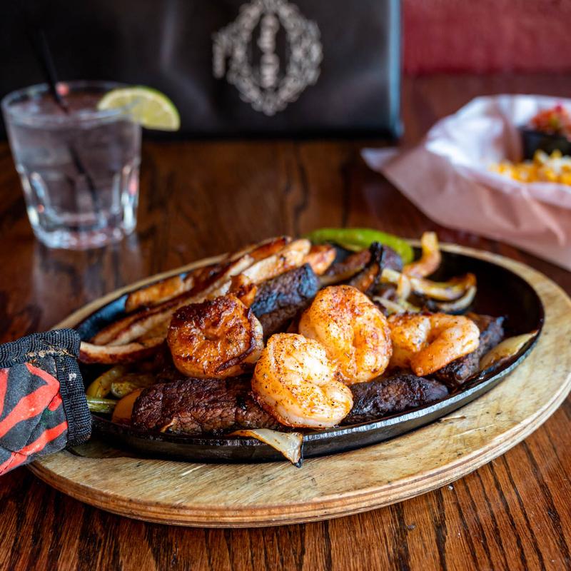 Fajitas, with shrimp, chicken, steak, portobello mushrooms, peppers, and onions.