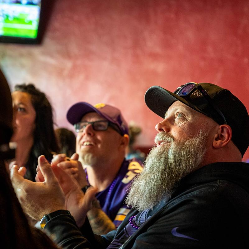 Patrons watching a game.