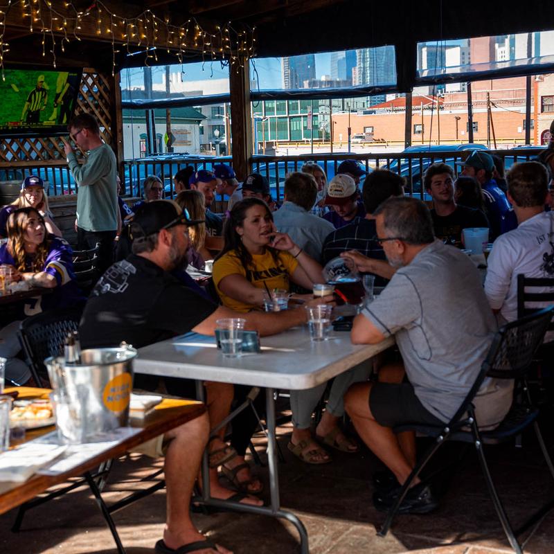 Crowded interior, customers eating and drinking.